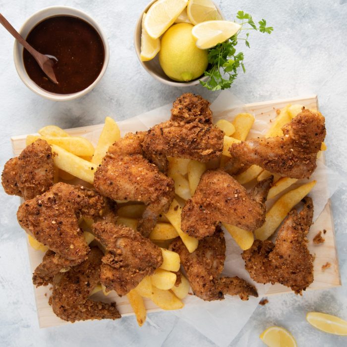 Hot-Wings-Dunked-In-BBQ-Sauce-With-Chips-1